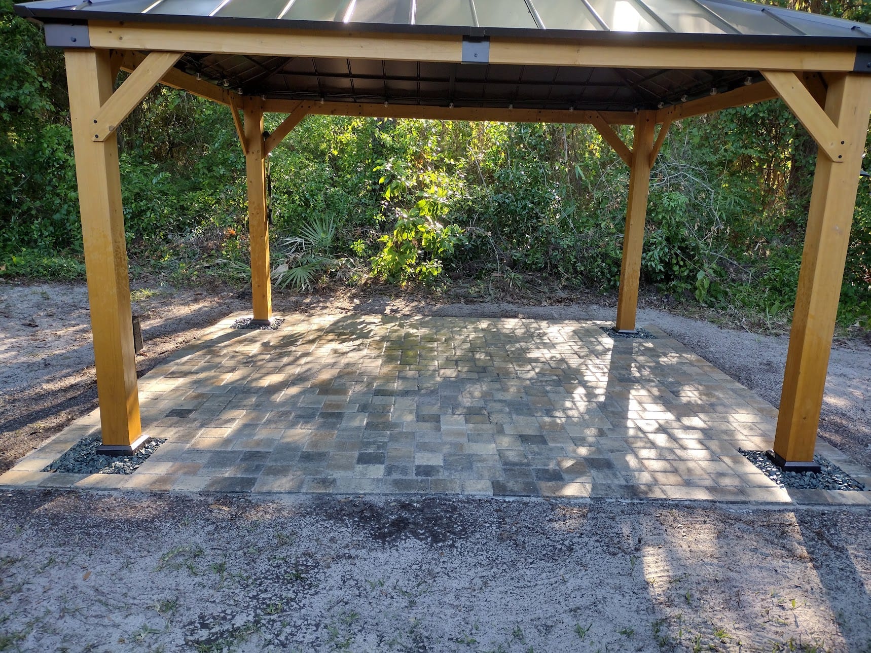 Pavers custom fit around legs of gazebo covering