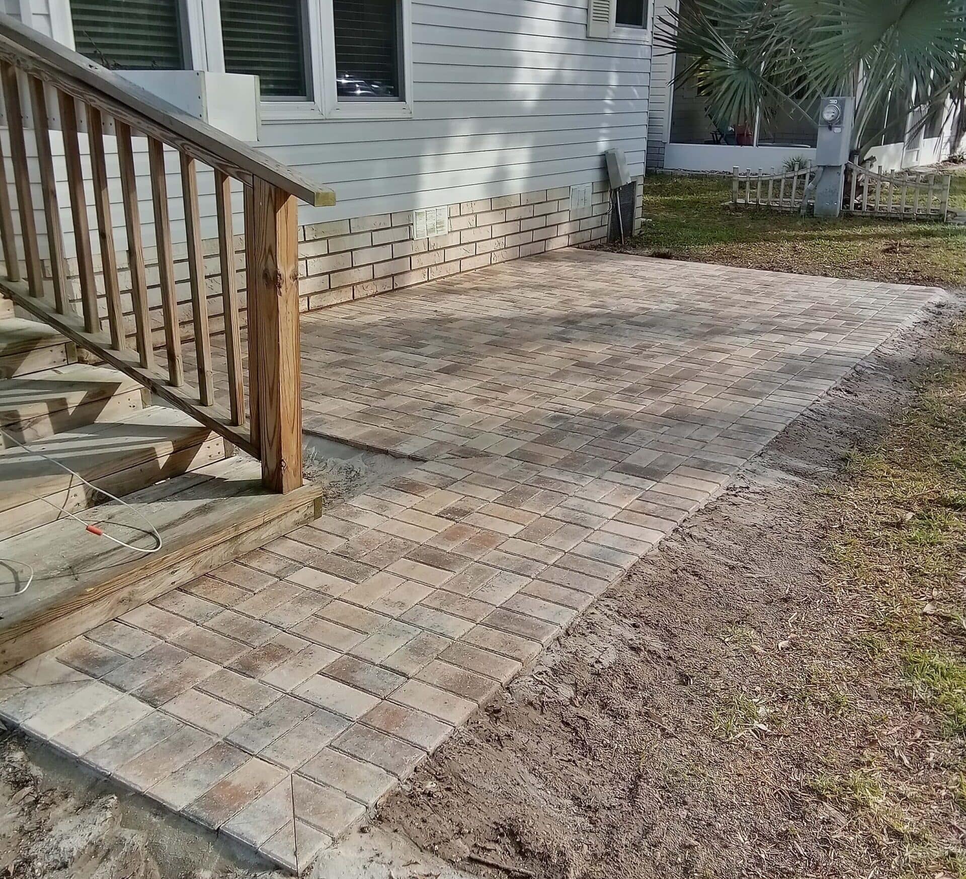 Paver walkway leading to railing